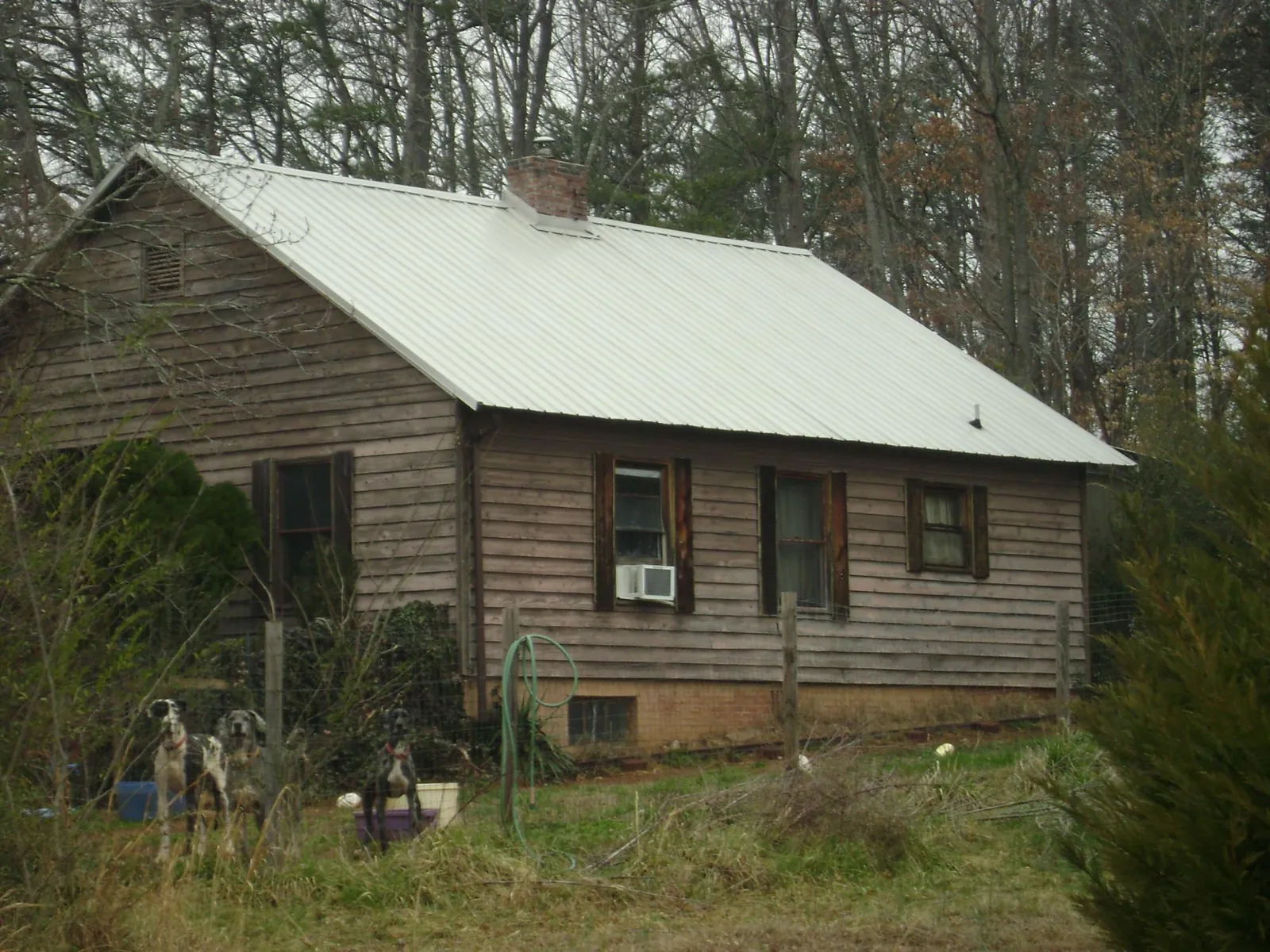White metal roof on an old wood sided farmhouse, from a Metal Roof Installation job in Turin